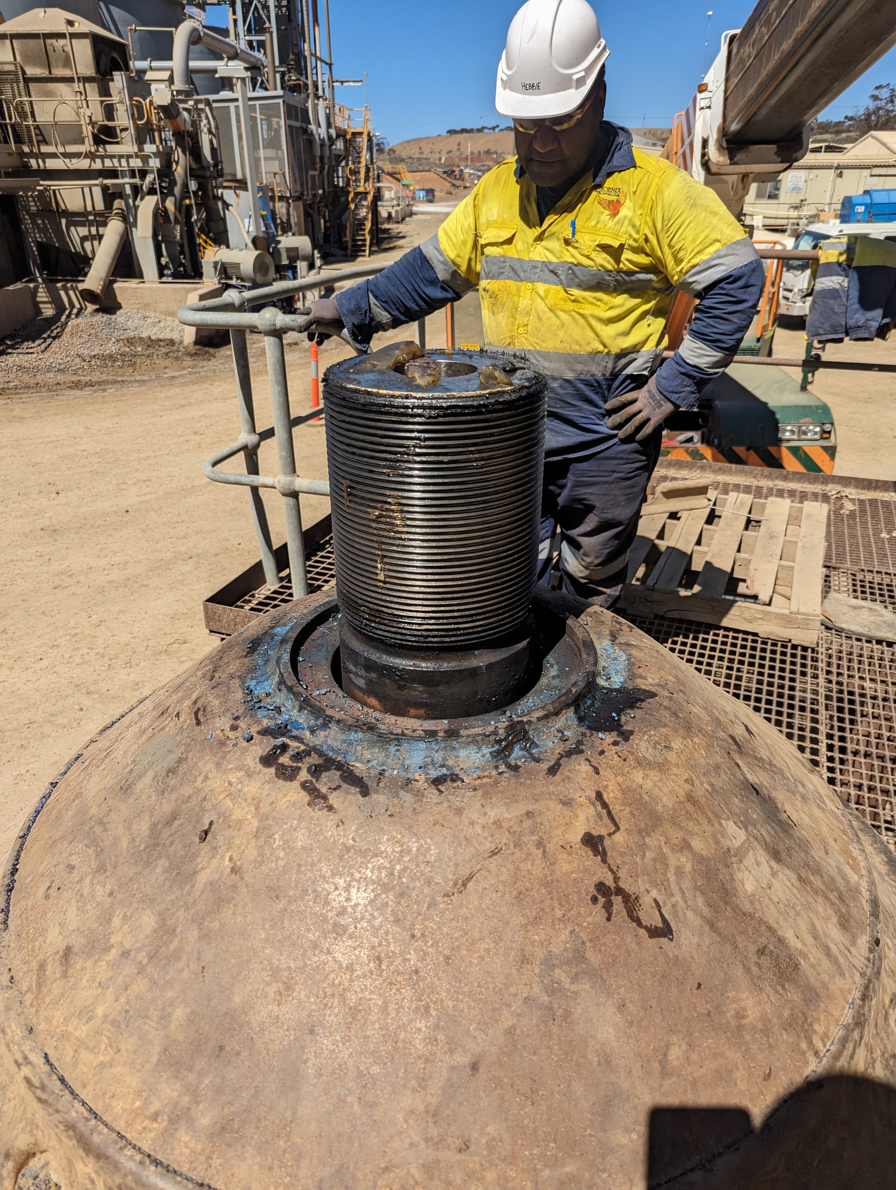 Phoenix Goldfields mechanical fitter servicing crusher head component on mine site